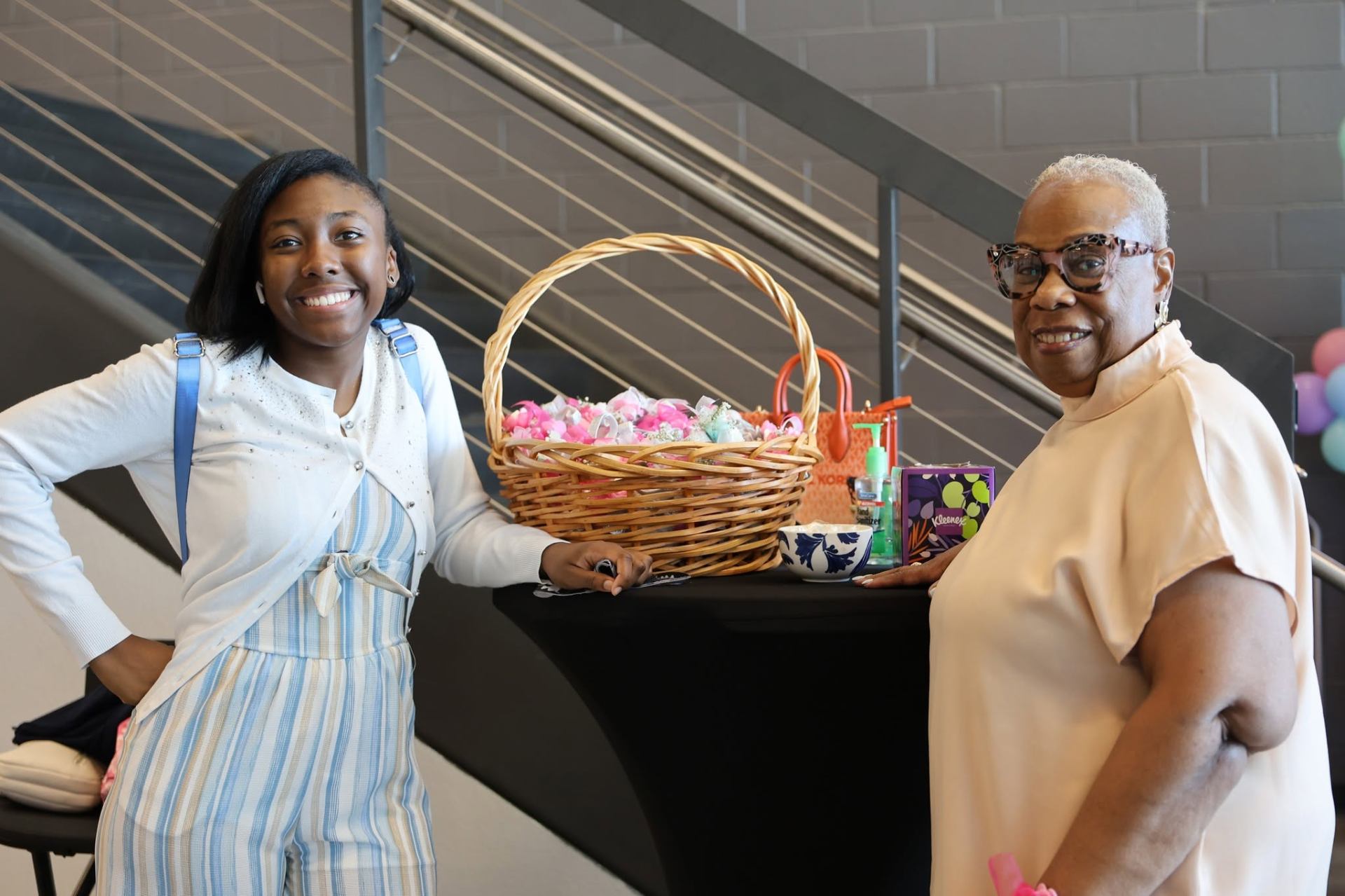 Two women beside a Mother's Day gift basket