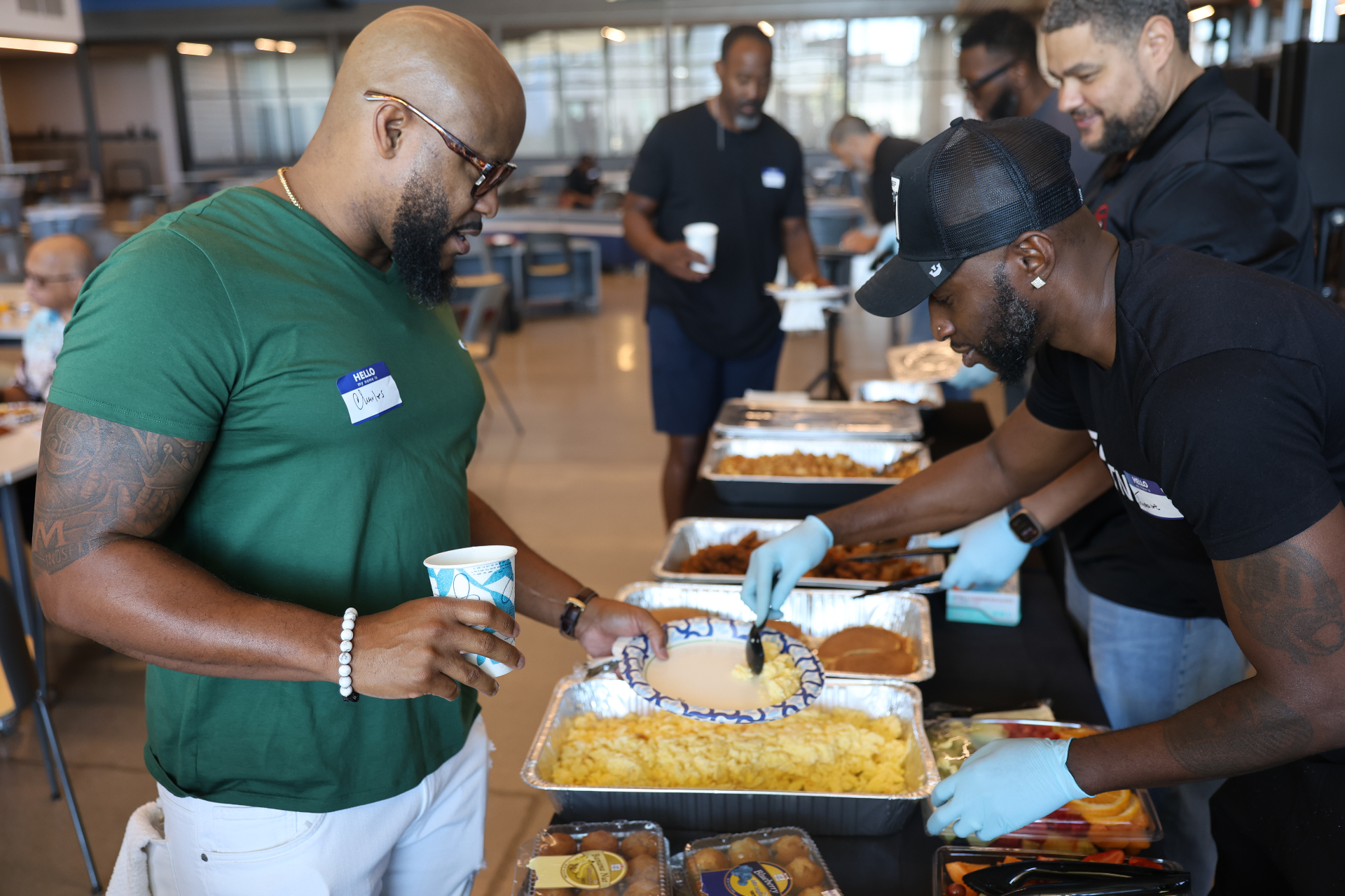 Men serving breakfast at the Father's Day gathering