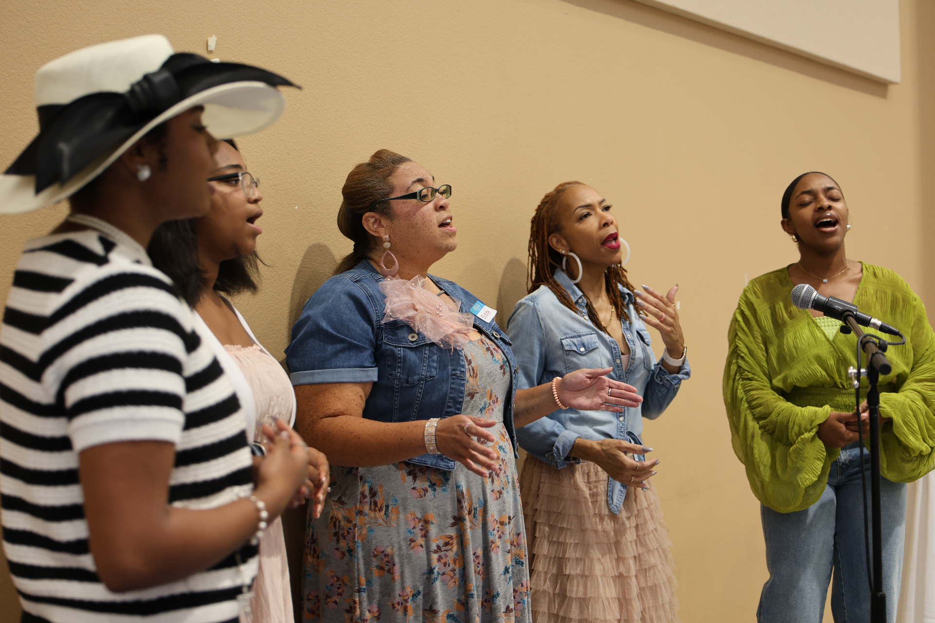 Women singing in worship at Spill the Tea